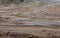 Broken dirt road after heavy rain. Swampy lagoon of a road demonstrates the most common problem in maintaining rural roads