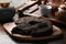 Broken disc shaped pu-erh tea and knife on wooden table