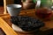 Broken disc shaped pu-erh tea on tray, closeup