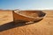 A broken, discarded boat in the desert