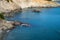 Broken down dock on cliffside leading to body of water