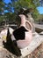 Broken earthenware jug standing at the well on the street