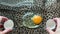 Broken egg with yolk and protein on leopard print