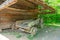 Broken farm wagon outdoors under barn