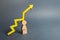 Broken figurine man and yellow arrow up. Body wearout from overwork. Increased risk to human health. Lack of sleep. High workload