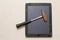 Broken flat glass of tablet and rusty hammer