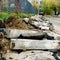 Broken freshly dug up old curbstones with pieces of an asphalt and earth lying on the road in Moscow.