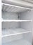 broken fridge. snow on freezer shelves. defrosting the fridge