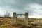 Broken gate on a field with barb wire