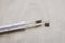 Broken glass mercury thermometer lying on floor