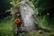 a broken gravestone overgrown with wildflowers