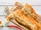 broken half pita bread caucasian, lying on a cutting board. Light wood background.