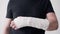 A broken hand in a gypsum bandage. Man tries to bend his fingers. Painful heavy movements of broken finger hands close
