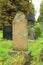 Broken headstone with flowers