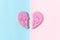 Broken heart, breakup, separation, divorce, significant other concept. Two halves of one heart on a pink background. Loss,