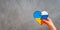 broken heart in the colors of the flag of Ukraine and Russia in children& x27;s hands on a gray background.