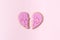 Broken heart concept. Divorse, quarrel. significant other. broken cookie in heart shape on pink background. Family psychotherapist