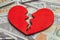 Broken heart because of money. Heart on a stack of cash dollars. Crack in the red heart, Breaking the relationship