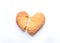 Broken heart-shaped sweet cookies on a white background. Heartbreak and unhappy love concept