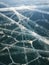 Broken ice cracks create unique and interesting patterns on the frozen lake Baikal, Siberia, Russia