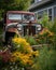 A broken jeep surrounded by curious native blooms. Abandoned landscape. AI generation