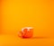 Broken large cup for tea on an orange background