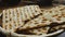 A broken matzah in a bread basket on the table rotates in a circle