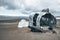 Broken military aircraft wreck at black sand beach in Solheimasandur against sky