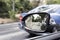 Broken mirrors of a car and in the background a blue car