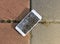 Broken mobile phone drop on stone paved sidewalk out
