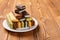 Broken multicolor sandwich cookies on wood table with copy space