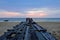 Broken old wooden pier bridge into the sea