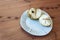 Broken open cherimoya fruit Annona cherimola on a white handmade plate