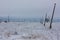 Broken phase electrical power lines with hoarfrost on the wooden electric poles on countryside in the winter after storm