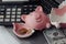 Broken piggy, calculator and dollar bills on laptop. Finance and bankruptcy concept