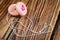 Broken pink toy yoyo on wooden background.