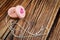Broken pink toy yoyo on wooden background.