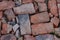 Broken red brick. Small stones.