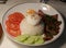 Broken rice or con tam with grilled pork, fried egg ,pickled carrot, and sliced cucumber