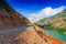 The broken road in the mountains and the dangerous bend sign. Crush cars concept