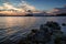 Broken rocky pier and lake at sunset in Finland