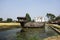 Broken ruins wood chinese sailing ship or damage wooden antique junk boat china style in pond of garden park for thai people