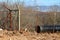 Broken rusted old wire fence with strong metal pipe frame and barb wire on top preventing access to local construction site