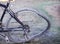 Broken spoke and damage crooked bicycle wheel from crash on the ground background