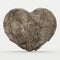 Broken stone heart on a white background.