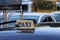 Broken taxi light sign or cab sign in drab yellow color with blue text on the car roof