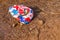 A broken and thrown old soccer ball lies on the ground