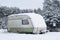 Broken tourist car trailer filled with snow