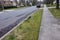 Broken vandalized mailbox post laying on the ground on a suburban street curb