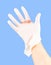 Broken white latex surgeon medical glove on caucasian hand isolated on blue monocolor background